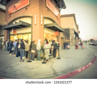 Blurred abstract long line of customer waiting at entrance for fashion store open during Black Friday in outlet mall, Texas, USA. Defocused holiday shopping background, retractable belt stanchion - Shutterstock ID 1241021377