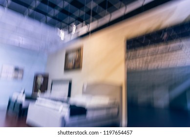 Blurred Abstract Low Angle View To Ceiling At Asian Furniture And Appliances Showroom Mega Retail Store In Texas, USA. Rows Of High-end Sofa And Living Room Supplies