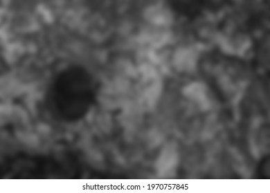 Blurred Abstract Monochromatic Background Of Grey Stone With Round Black Hole