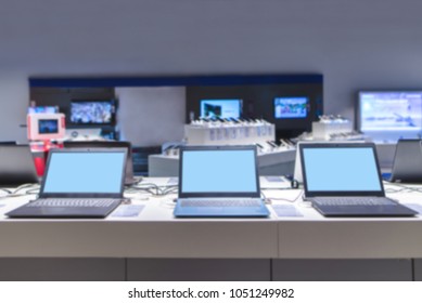 Blurred Abstract Photo Of Laptops And Electronics Store.