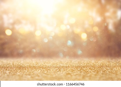 blurred abstract photo of light burst among trees and glitter golden bokeh lights - Shutterstock ID 1166456746