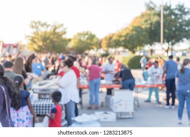 Blurred Abstract Serving Line At Church Festival Near Dallas, Texas, USA. Defocused Long Queue Of Diverse And Multicultural People Attending Community Event And Soup Kitchen