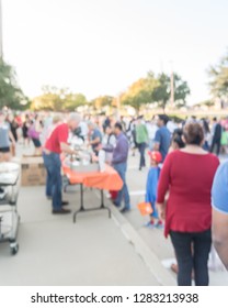 Blurred Abstract Serving Line At Church Festival Near Dallas, Texas, USA. Defocused Long Queue Of Diverse And Multicultural People Attending Community Event And Soup Kitchen