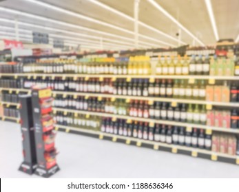 Blurred Abstract Wine Aisle With Price Tags At Grocery Store In Texas, America. Defocused Rows Of Red, White Wine Liquor Bottles On Supermarket Shelf. Alcoholic Beverage Concept Background