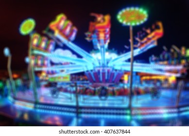 Blurred Amusement park ride at night. conceptual image of entertainment & fun