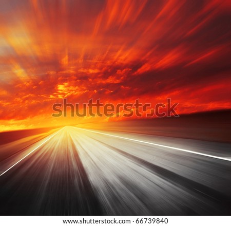 Blurred asphalt road and red clouds