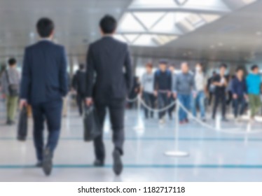 Blurred Back Of Business Men Walking At Career Job Fair.