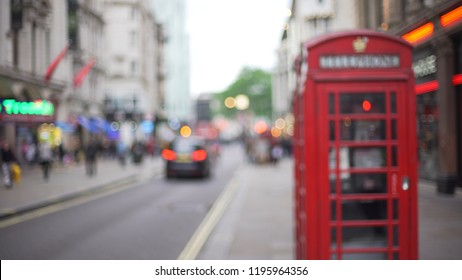 Blurred Backdrop Of London City Sidewalk With Iconic Red Phone Booth