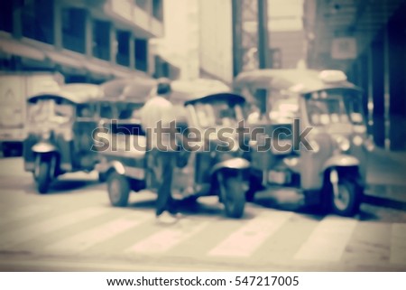 Blurred  background abstract and can be illustration to article of threewheeler classic motorised tuk-tuk taxi in Bangkok, Thailand