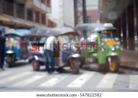 Blurred  background abstract and can be illustration to article of threewheeler classic motorised tuk-tuk taxi in Bangkok, Thailand