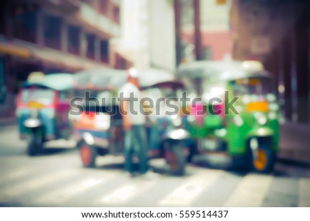 Blurred  background abstract and can be illustration to article of threewheeler classic motorised tuk-tuk taxi in Bangkok, Thailand