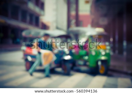 Blurred  background abstract and can be illustration to article of threewheeler classic motorised tuk-tuk taxi in Bangkok, Thailand
