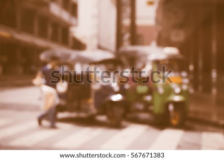 Blurred  background abstract and can be illustration to article of threewheeler classic motorised tuk-tuk taxi in Bangkok, Thailand