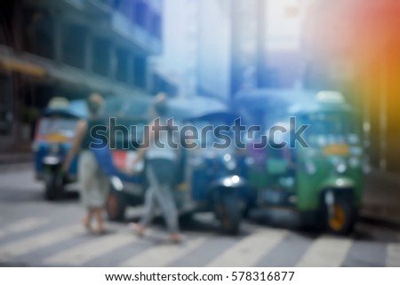 Blurred  background abstract and can be illustration to article of threewheeler classic motorised tuk-tuk taxi in Bangkok, Thailand