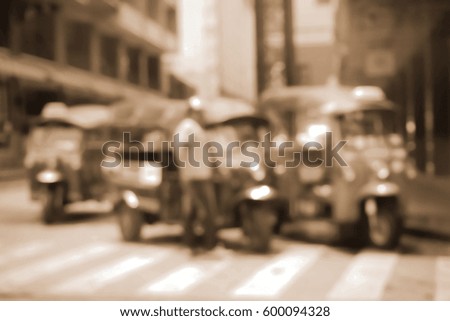 Blurred  background abstract and can be illustration to article of threewheeler classic motorised tuk-tuk taxi in Bangkok, Thailand