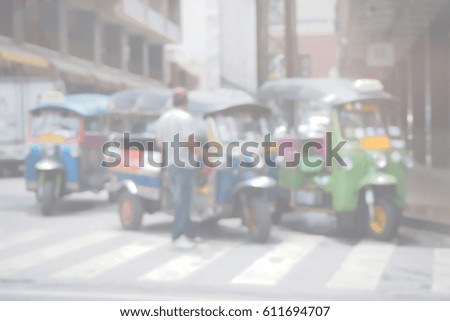 Blurred  background abstract and can be illustration to article of threewheeler classic motorised tuk-tuk taxi in Bangkok, Thailand