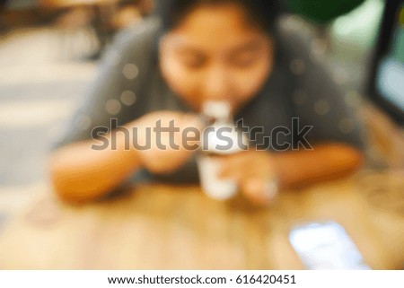 BLURRED BACKGROUND ASIAN FAT WOMAN EAT ICE-CREAM