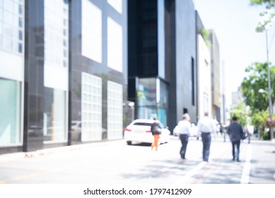 Blurred Background Of Asian People, Businessman Walking On Sidewalk And Traffic On The Road With Business Building, Business Area In The City, Seoul Korea, Perspective.