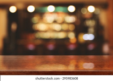 Blurred Background Of Bar And Brown Desk Space 