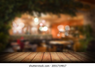 Blurred Background Of A Bar. Wooden Worktop In Foreground