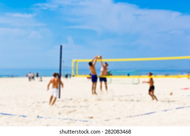 Blurred Background With Beach Volleyball Players.