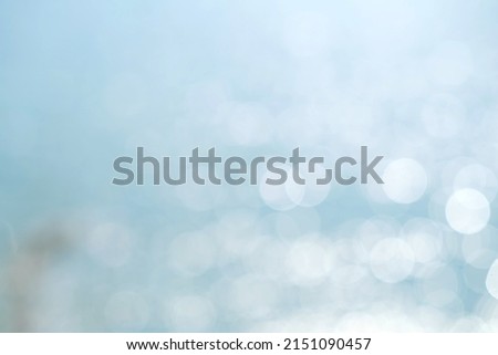 Blurred background of the blue sea and bokeh sunlight.