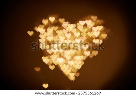 Blurred background, bokeh in the form of a heart, gold hearts bokeh as a background. Valentine's Day concept. The 14th of February.