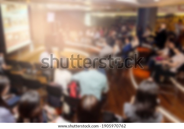 Blurred background of business people in conference\
hall or seminar room.