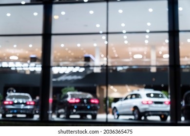 Blurred Background With Car Dealership Exterior. Abstract Blurred Photo Of Modern Building Motor Showroom. Blur Car Show Room Office Bokeh Lights. Automobile Retail Shop