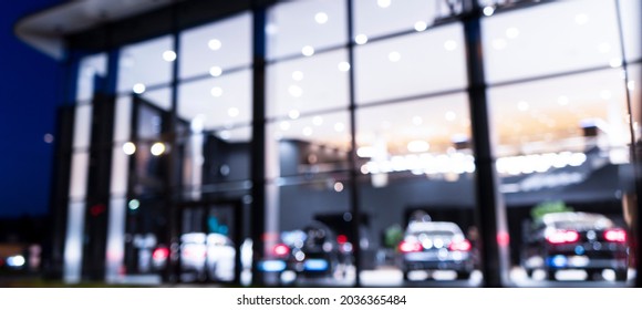 Blurred background with car dealership exterior. Abstract blurred photo of modern building motor showroom. Blur car show room office bokeh lights. Automobile retail shop