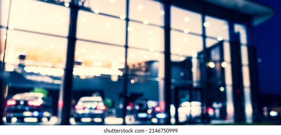 Blurred background with car dealership exterior. Abstract blurred photo of modern building motor showroom. Blur car show room office bokeh lights. Automobile retail shop - Shutterstock ID 2146750999