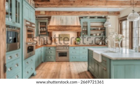 Blurred background of charming rustic kitchen featuring blue cabinets, wooden beams, and modern appliances. perfect for a warm and inviting home atmosphere.