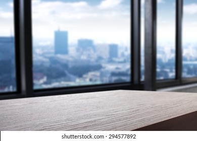 Blurred Background Of City And Dark Desk Space 