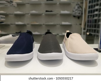 Blurred Background Of Comfortable New Summer Sneaker Collection Display In Store Shelf. Design To Wear During Happy Holidays Travel