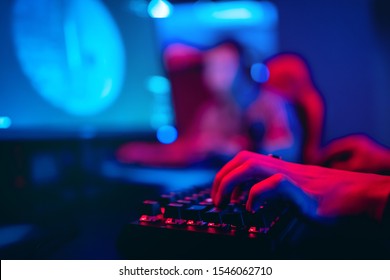 Blurred Background Computer, Keyboard, Blue And Red Lights. Concept ESports Arena For Gamer Playing Tournaments.