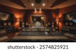 Blurred background of a detailed view of a modern music recording studio featuring mixing console, acoustic treatment, and professional equipment that captures creative sound production