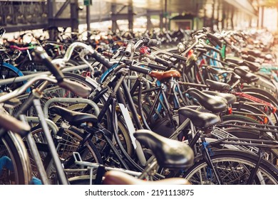 Blurred background of different bicycles in the parking lot, rainy day. Parked bicycles in Amsterdam - Powered by Shutterstock