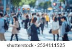 Blurred background of a dynamic scene of a crowded urban crosswalk filled with office workers, showcasing the busy lifestyle and movement in a city during the day.