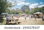 Blurred background of an energetic urban plaza comes alive during a weekend festival, featuring lively crowds, colorful tents, and a vibrant atmosphere perfect for social gatherings.