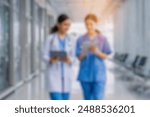 blurred for background. blurred figures of doctors and nurses in a hospital corridor. Doctors and nurses walking in hospital hallway. blurred motion. Moving human figure in the clinic corridor	