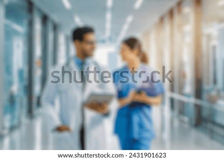 blurred for background. blurred figures of doctors and nurses in a hospital corridor. Doctors and nurses walking in hospital hallway. blurred motion. Moving human figure in the clinic corridor