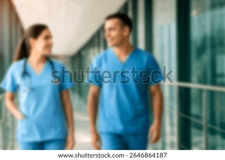 blurred for background. blurred figures of doctors and nurses in a hospital corridor. Doctors and nurses walking in hospital hallway. blurred motion. Moving human figure in the clinic corridor
