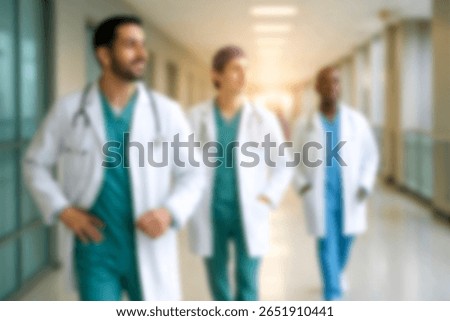 blurred for background. blurred figures of doctors and nurses in a hospital corridor. Doctors and nurses walking in hospital hallway. blurred motion. Moving human figure in the clinic corridor