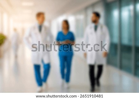 blurred for background. blurred figures of doctors and nurses in a hospital corridor. Doctors and nurses walking in hospital hallway. blurred motion. Moving human figure in the clinic corridor