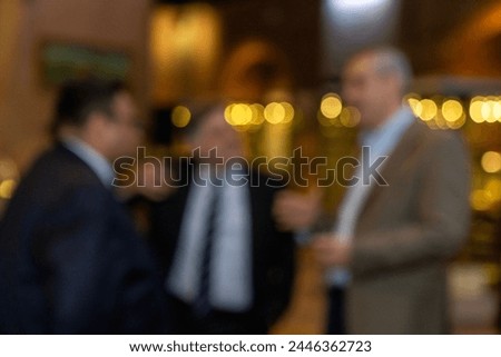 blurred for background.  blurred figures of suits men in a event, meeting, conference.  business people meet up in success night club or entertainment bar and restaurant, party lifestyle concept