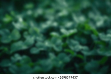 blurred background. A fire hydrant sits atop a lush green field, surrounded by nature.