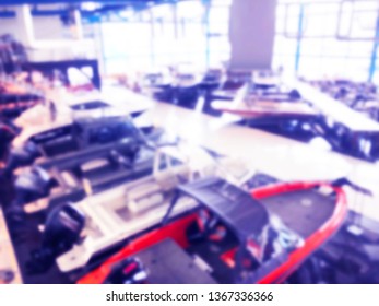 Blurred Background With Fishing Motor Boat In The Dealership Store. Blur Motorboat Showroom Background. Bokeh Light