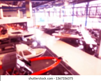 Blurred Background With Fishing Motor Boat In The Dealership Store. Blur Motorboat Showroom Background. Bokeh Light