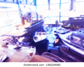 Blurred Background With Fishing Motor Boat In The Dealership Store. Blur Motorboat Showroom Background. Bokeh Light