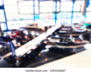 Blurred Background With Fishing Motor Boat In The Dealership Store. Blur Motorboat Showroom Background. Bokeh Light